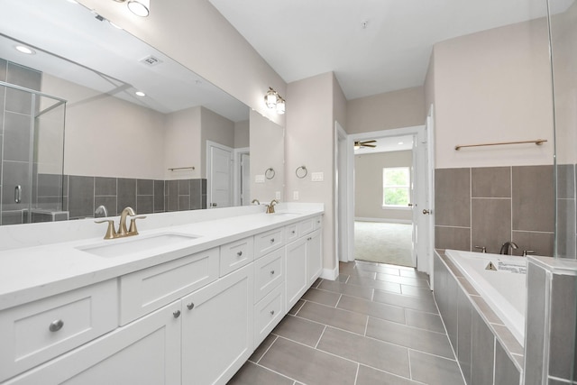 3913 Griggs Rd, Houston, TX 77021 - full bath with double vanity, a garden tub, tile patterned flooring, a ceiling fan, and a shower with shower door