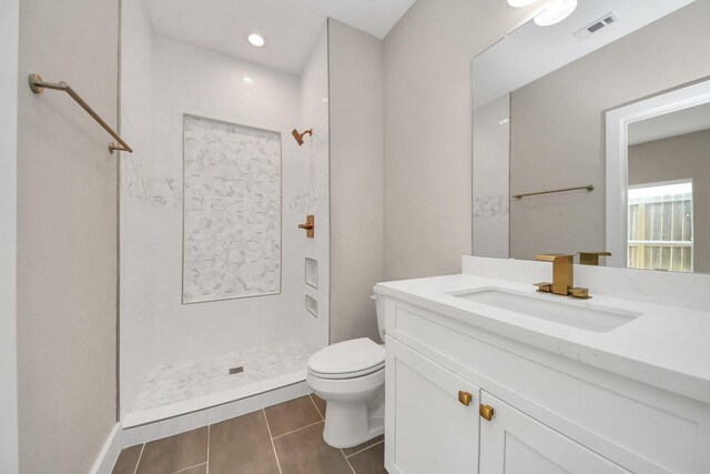 3913 Griggs Rd, Houston, TX 77021 - full bathroom featuring toilet, a tile shower, vanity, and tile patterned flooring