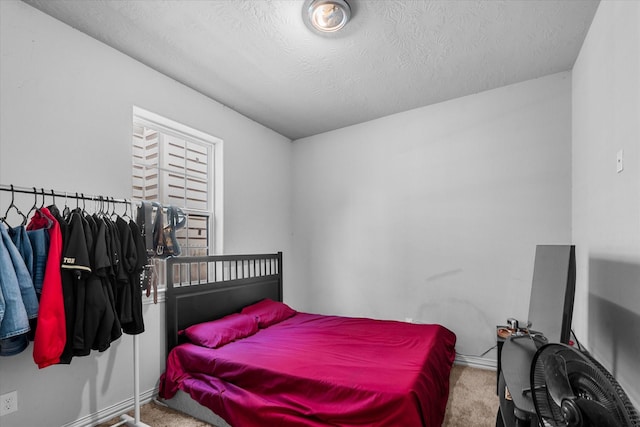9307 Seeker St, Houston, TX 77028 - bedroom featuring carpet flooring, baseboards, and a textured ceiling