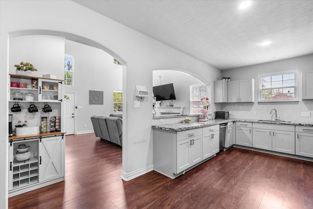 9307 Seeker St, Houston, TX 77028 - kitchen featuring a sink, dark wood finished floors, light stone counters, healthy amount of natural light, and recessed lighting