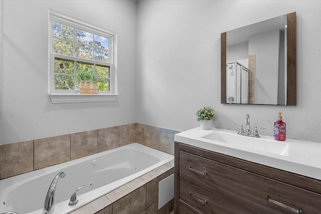 9307 Seeker St, Houston, TX 77028 - full bathroom with vanity, a jetted tub, and a shower with shower door