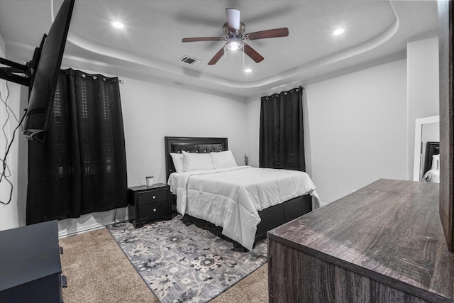 9307 Seeker St, Houston, TX 77028 - carpeted bedroom with a tray ceiling, recessed lighting, and a ceiling fan