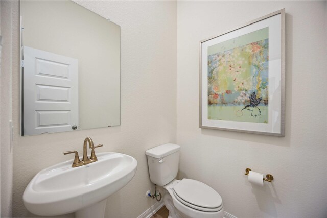 16800 Needlepoint Dr, Conroe, TX 77302 - bathroom featuring a sink, toilet, and baseboards