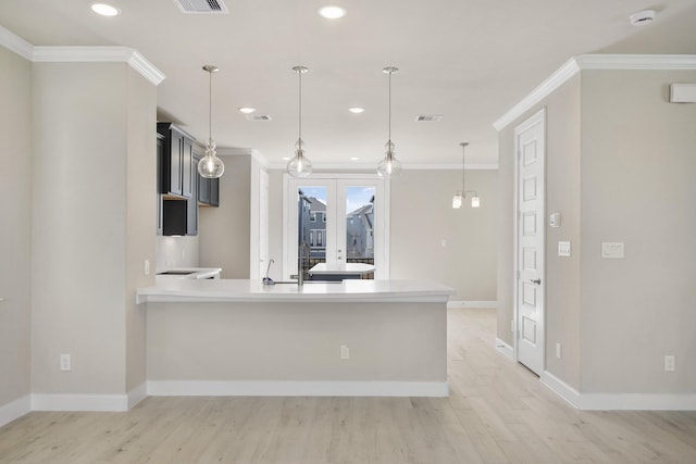 2033 Millbridge Spring Ln, Houston, TX 77051 - kitchen featuring light wood finished floors, crown molding, recessed lighting, light countertops, and baseboards