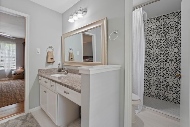 2828 S Logrun Cir, The Woodlands, TX 77380 - ensuite bathroom featuring a tile shower, vanity, and toilet