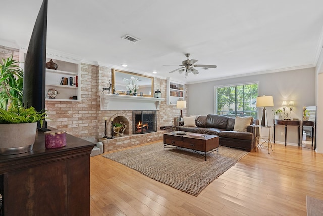 2828 S Logrun Cir, The Woodlands, TX 77380 - living area featuring a fireplace, a ceiling fan, ornamental molding, and wood finished floors