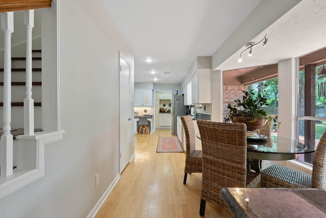 2828 S Logrun Cir, The Woodlands, TX 77380 - dining space featuring light wood-style flooring and baseboards