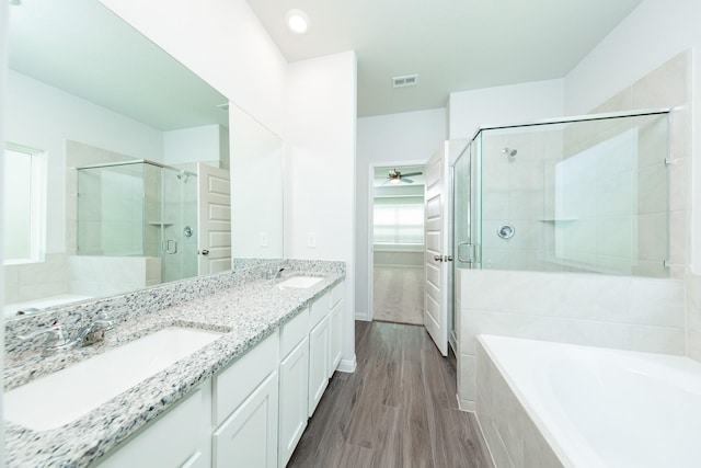 13228 Musky Dr, Conroe, TX 77384 - bathroom featuring a stall shower, a garden tub, double vanity, and ceiling fan