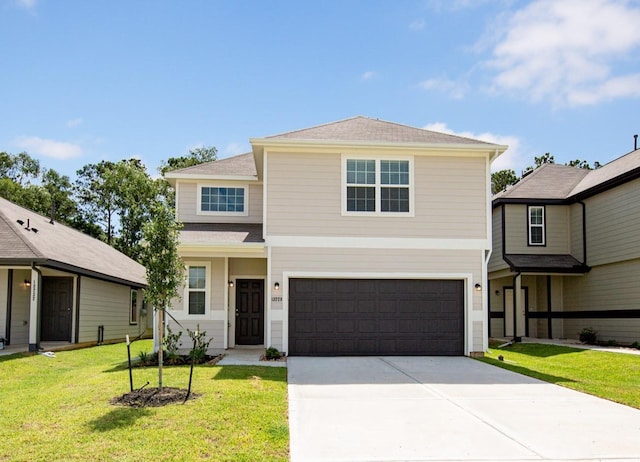 13228 Musky Dr, Conroe, TX 77384 - traditional home featuring a garage, driveway, a front yard, and a shingled roof