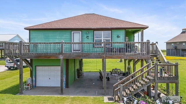 986 Tuna Dr, Crystal Beach, TX 77650 - view of front facade with an attached garage, stairs, a shingled roof, and a front yard