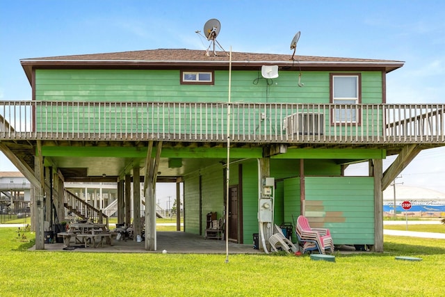 986 Tuna Dr, Crystal Beach, TX 77650 - rear view of house featuring a wooden deck, a lawn, and a patio