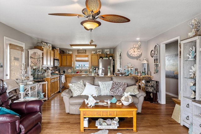 986 Tuna Dr, Crystal Beach, TX 77650 - living room featuring a ceiling fan and light wood finished floors