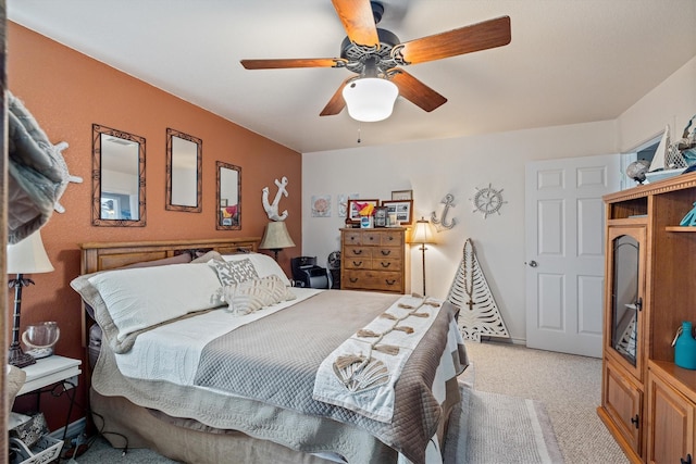 986 Tuna Dr, Crystal Beach, TX 77650 - bedroom with light colored carpet and ceiling fan