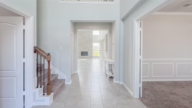 14227 Angelina Dr, Baytown, TX 77523 - hall with light tile patterned floors, ornamental molding, and stairs