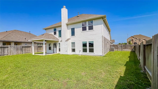14227 Angelina Dr, Baytown, TX 77523 - back of house featuring a chimney, a patio, and a shingled roof