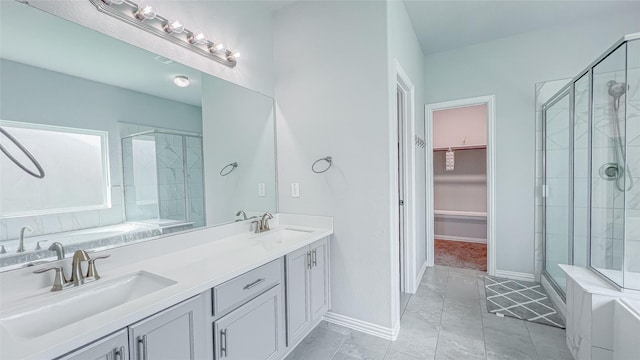 14227 Angelina Dr, Baytown, TX 77523 - bathroom with a shower stall, a walk in closet, double vanity, baseboards, and a tub to relax in