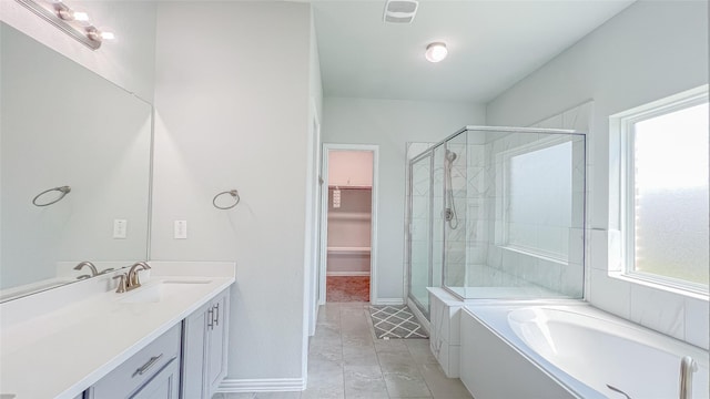 14227 Angelina Dr, Baytown, TX 77523 - full bath with a stall shower, vanity, a garden tub, a walk in closet, and baseboards