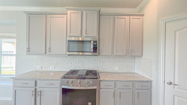 14227 Angelina Dr, Baytown, TX 77523 - kitchen featuring appliances with stainless steel finishes, tasteful backsplash, ornamental molding, and light stone countertops