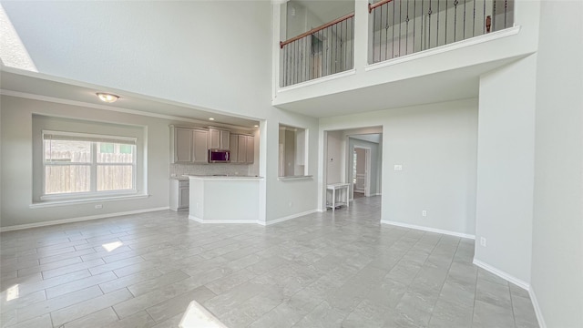 14227 Angelina Dr, Baytown, TX 77523 - unfurnished living room featuring a high ceiling and baseboards