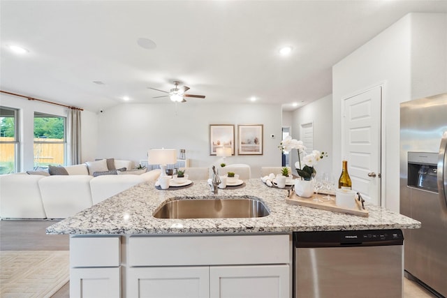 11608 Whirlaway Dr, Willis, TX 77318 - kitchen with stainless steel appliances, open floor plan, a sink, an island with sink, and ceiling fan