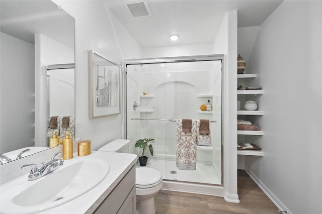 11608 Whirlaway Dr, Willis, TX 77318 - bathroom with toilet, wood finished floors, vanity, and a shower stall