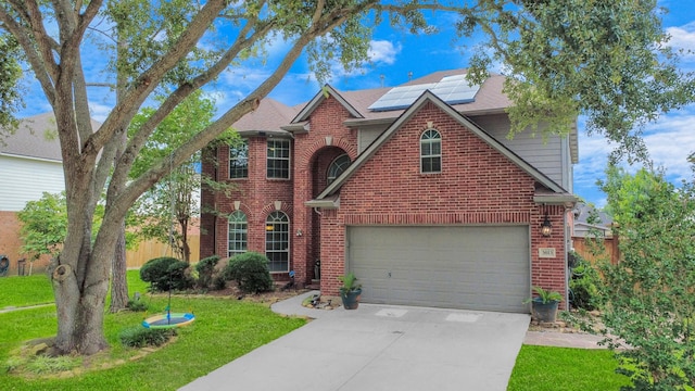 3613 Pine Valley Dr, Pearland, TX 77581 - traditional-style home with brick siding, a front yard, driveway, solar panels, and a shingled roof