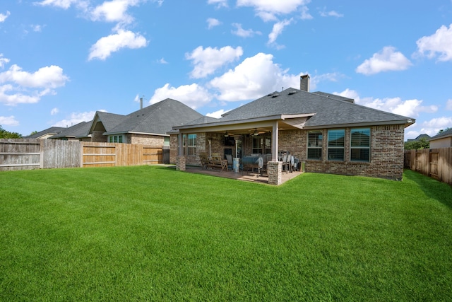 19823 Sonterra Ln, Richmond, TX 77407 - rear view of house featuring brick siding, a ceiling fan, a patio, a shingled roof, and a chimney