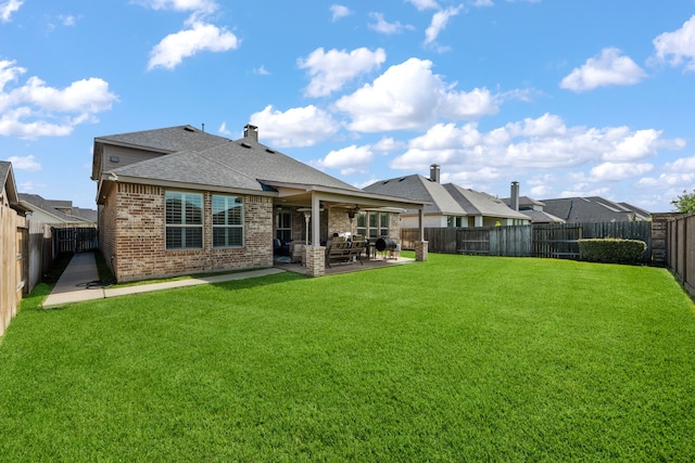 19823 Sonterra Ln, Richmond, TX 77407 - back of property with brick siding, a shingled roof, a patio area, and a ceiling fan