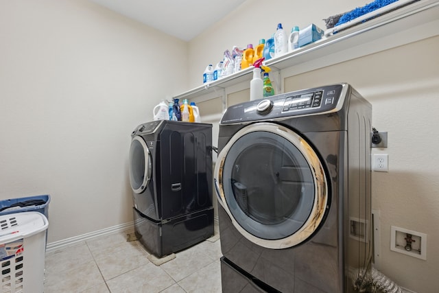 19823 Sonterra Ln, Richmond, TX 77407 - laundry room featuring light tile patterned flooring and washer and clothes dryer