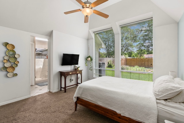 17322 Camberwell Green Ln, Houston, TX 77070 - carpeted bedroom with multiple windows, connected bathroom, baseboards, ceiling fan, and lofted ceiling