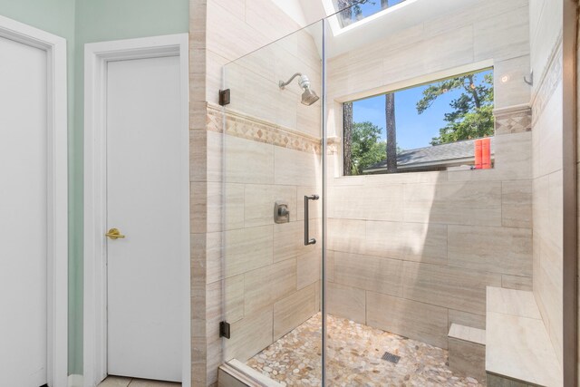 17322 Camberwell Green Ln, Houston, TX 77070 - full bathroom with a shower stall and a skylight