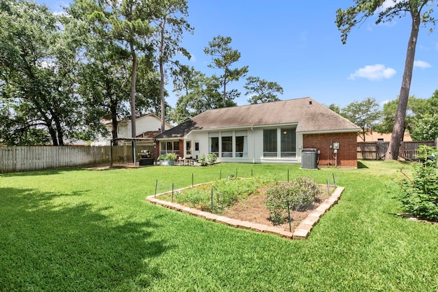 17322 Camberwell Green Ln, Houston, TX 77070 - back of property with cooling unit, a garden, brick siding, and a shingled roof
