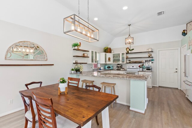 17322 Camberwell Green Ln, Houston, TX 77070 - dining room with vaulted ceiling, light wood finished floors, recessed lighting, and a chandelier