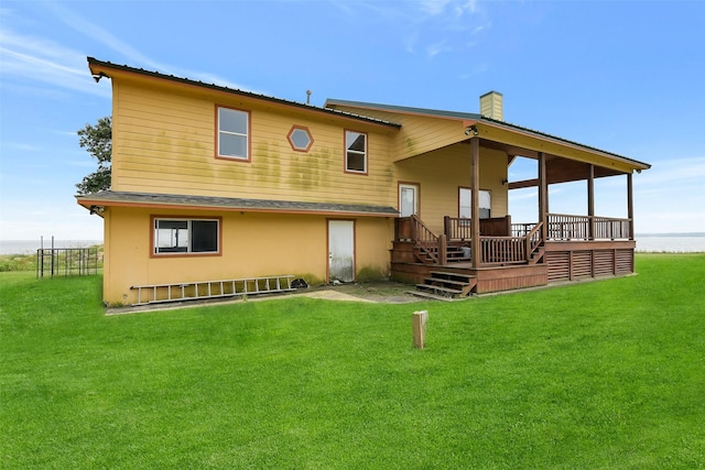 245 Bridgewater, Onalaska, TX 77360 - rear view of house featuring a yard, a chimney, and a deck with water view