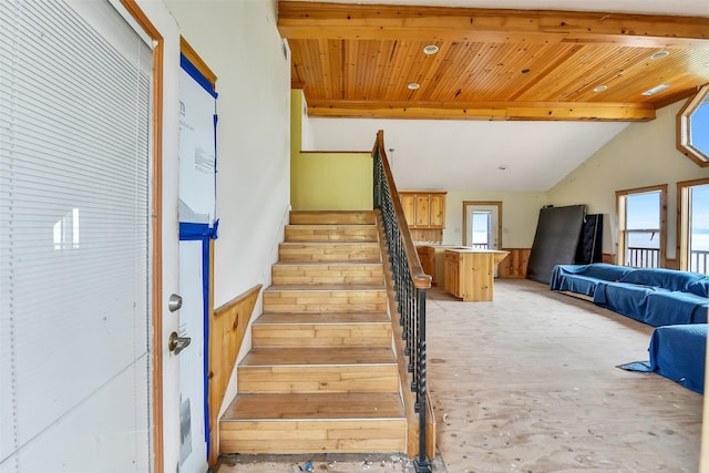 245 Bridgewater, Onalaska, TX 77360 - stairs with wood walls, wood ceiling with exposed beams, and a wainscoted wall