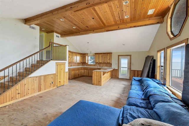 245 Bridgewater, Onalaska, TX 77360 - living room featuring stairway, wainscoting, light wood-type flooring, and wooden walls