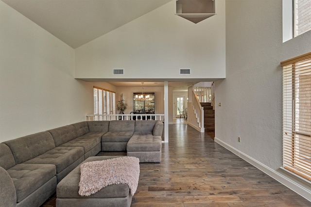 52 S Havenridge Dr, The Woodlands, TX 77381 - living room featuring a chandelier, high vaulted ceiling, dark wood finished floors, stairs, and baseboards