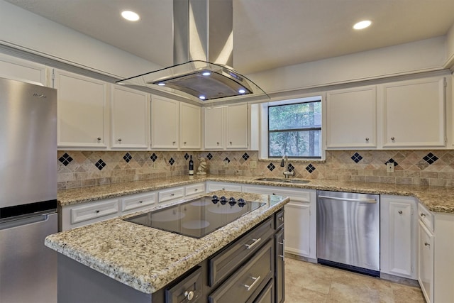 52 S Havenridge Dr, The Woodlands, TX 77381 - kitchen featuring appliances with stainless steel finishes, a sink, island exhaust hood, white cabinetry, and tasteful backsplash