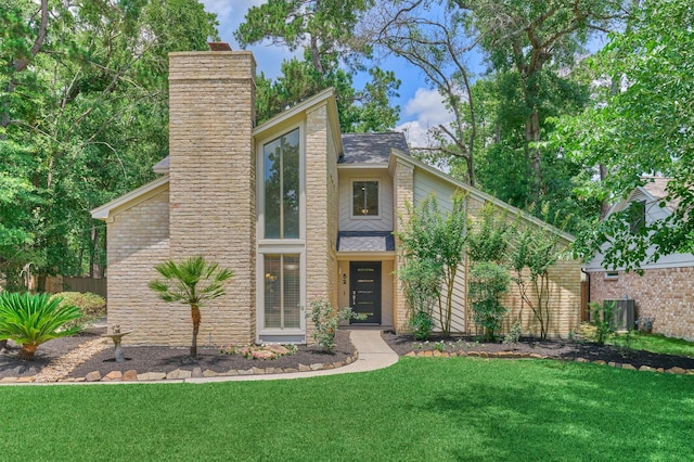 52 S Havenridge Dr, The Woodlands, TX 77381 - mid-century modern home featuring a chimney and a shingled roof