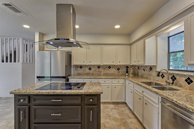 52 S Havenridge Dr, The Woodlands, TX 77381 - kitchen with appliances with stainless steel finishes, a sink, island range hood, backsplash, and recessed lighting