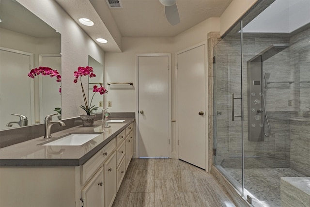 52 S Havenridge Dr, The Woodlands, TX 77381 - bathroom featuring double vanity, a stall shower, a ceiling fan, and recessed lighting