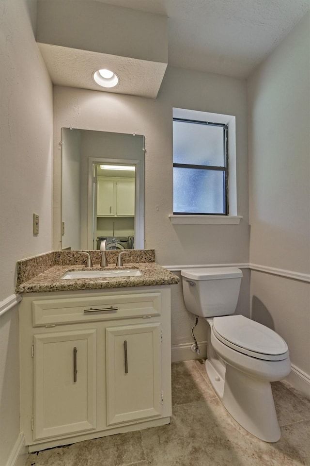 52 S Havenridge Dr, The Woodlands, TX 77381 - half bath featuring toilet, baseboards, and vanity
