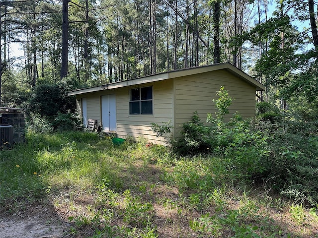 1883 Winding Creek Dr, Trinity, TX 75862 - view of side of property featuring an outbuilding and central air condition unit
