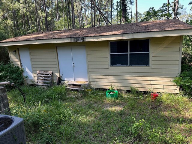 1883 Winding Creek Dr, Trinity, TX 75862 - rear view of house with central AC unit and crawl space