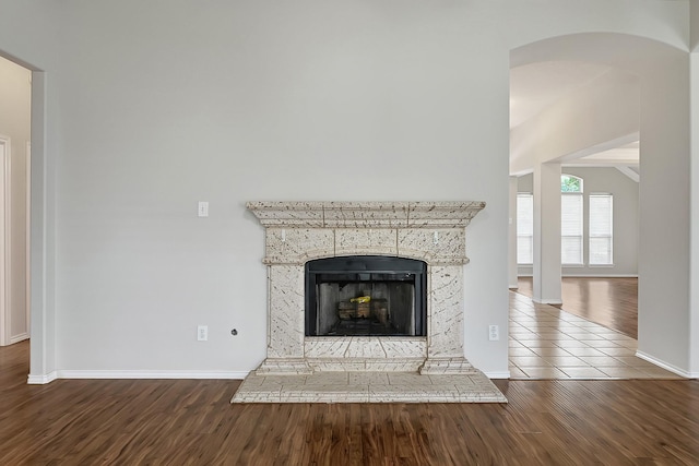 9927 Barr Lake Dr, Houston, TX 77095 - detailed view of wood finished floors, baseboards, and a fireplace with raised hearth