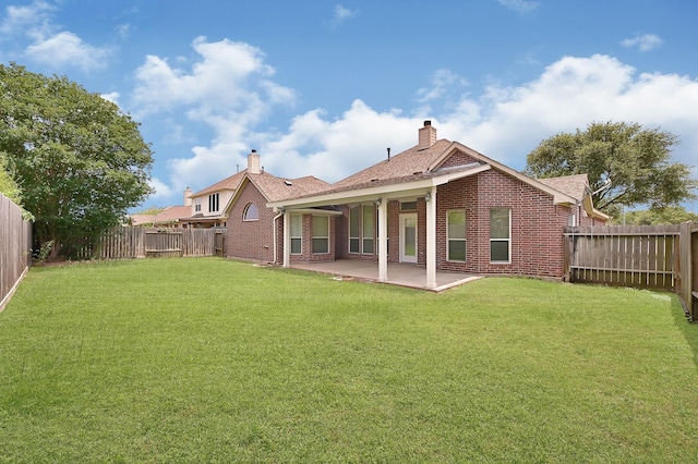 9927 Barr Lake Dr, Houston, TX 77095 - rear view of house with brick siding, a patio, a chimney, and roof with shingles
