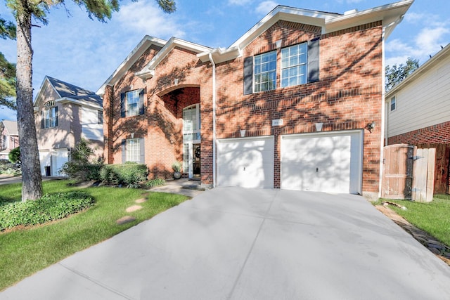 10138 Bayou Manor Ln, Houston, TX 77064 - traditional-style house featuring concrete driveway, brick siding, a garage, a front yard, and a gate