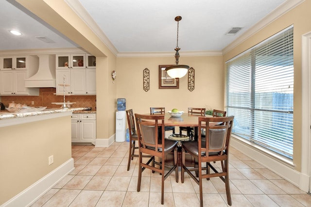 10138 Bayou Manor Ln, Houston, TX 77064 - dining area with light tile patterned floors, crown molding, and baseboards