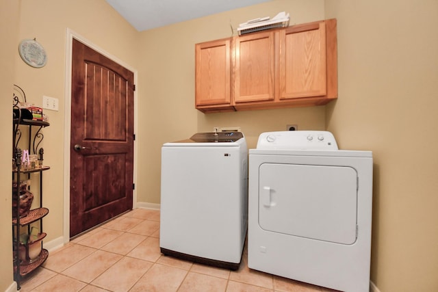 10138 Bayou Manor Ln, Houston, TX 77064 - washroom with cabinet space, separate washer and dryer, light tile patterned flooring, and baseboards