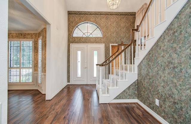 5810 Springton Ln, Spring, TX 77379 - foyer entrance with wallpapered walls, stairway, dark wood finished floors, crown molding, and baseboards